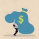 Businessman burdened by a blue sack of money
