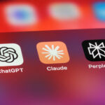 Photo illustrating AI concept with images of Claude and ChatGPT icons.