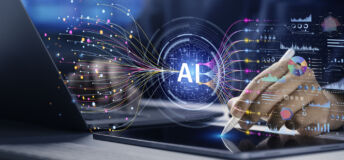 Image of a digital AI button hovering over a laptop, symbolizing the synthesis of data.